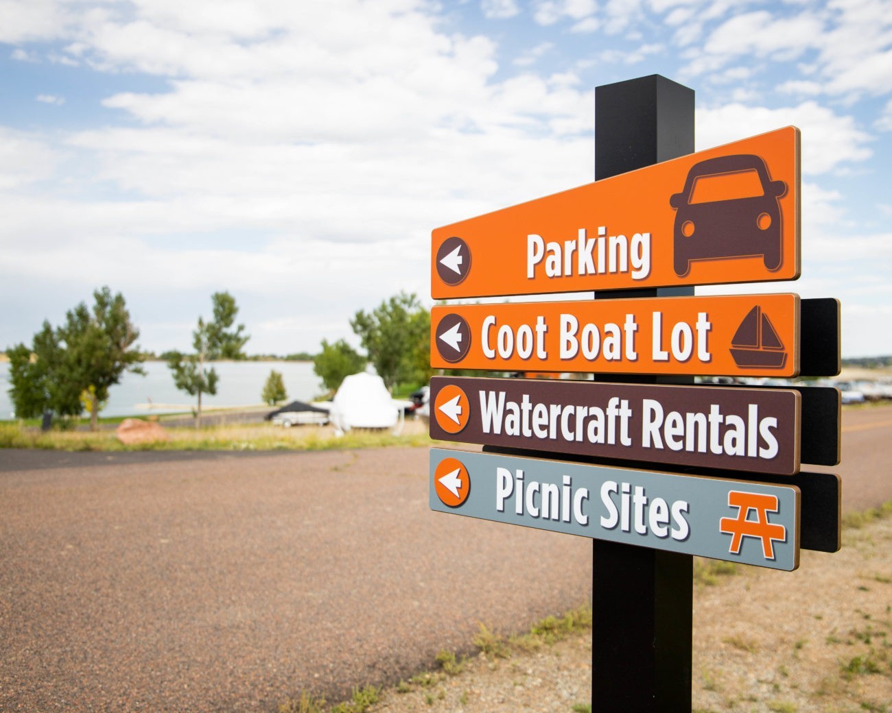 Modern wayfinding signage with clear directional arrows and icons, guiding visitors